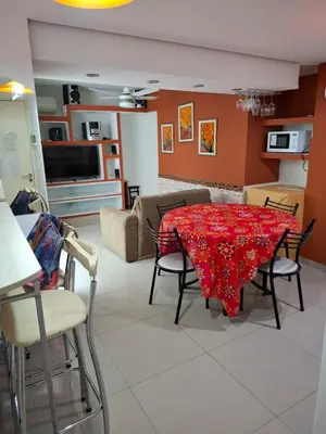 a living room with a red table and chairs at Departamento Eutico in Villa Carlos Paz