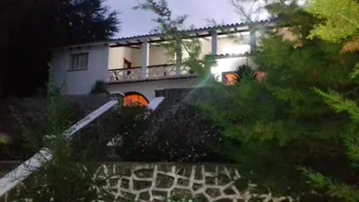 a house with a fence in front of it at El Cortijo de la villa in Villa Independencia