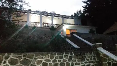a building with a stone staircase in front of a building at El Cortijo de la villa in Villa Independencia