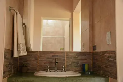 a bathroom with a sink and a mirror at La Catalina Traslasierra in Nono