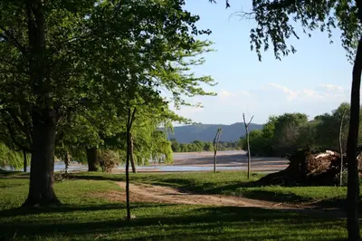a dirt road in a park with trees at La Catalina Traslasierra in Nono