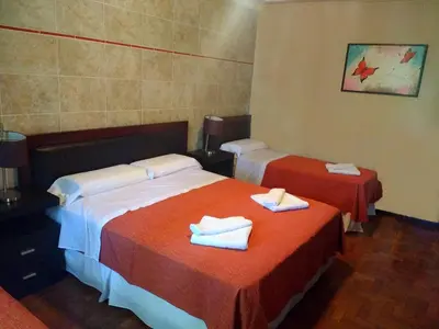 a hotel room with two beds with towels on them at Hotel Sierras in Mina Clavero