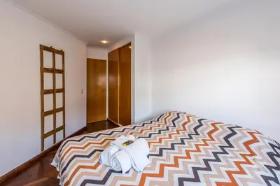 a bedroom with a bed with towels on it at Lofty Departamentos Temporarios in Cordoba
