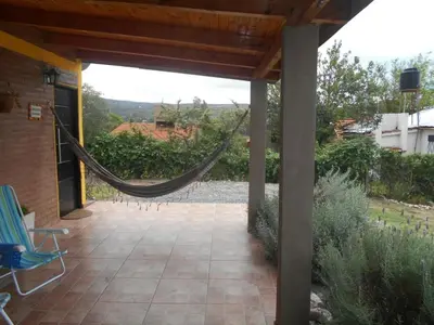 a patio with a hammock in a house at Cabaña Refugio De Caminantes in Tanti