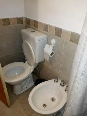 a bathroom with a toilet and a sink at Cabaña Refugio De Caminantes in Tanti