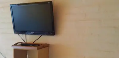 a flat screen tv hanging on a wall at Cabaña Refugio De Caminantes in Tanti