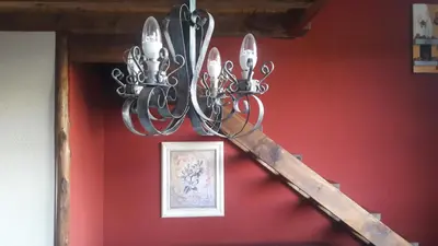 a chandelier hanging from a red wall at Quinta Santana in José de la Quintana