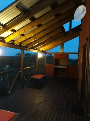 a wooden deck with a bench on a roof at Quinta Santana in José de la Quintana