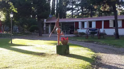 a house with a flag and a basket of flowers at Quinta Santana in José de la Quintana