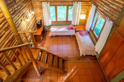 an overhead view of a bedroom in a log cabin at Grenouille in Villa General Belgrano