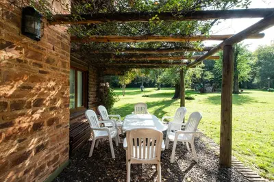 a table and chairs sitting under a pergola at Grenouille in Villa General Belgrano