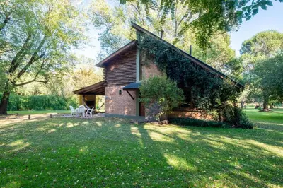 a brick house with ivy on the side of it at Grenouille in Villa General Belgrano