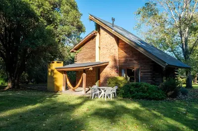 a cabin with a table and chairs in front of it at Grenouille in Villa General Belgrano