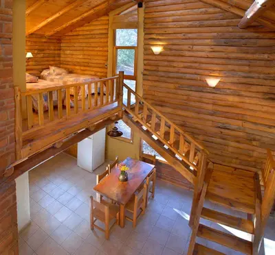 an overhead view of a wooden cabin with a table and stairs at Grenouille in Villa General Belgrano
