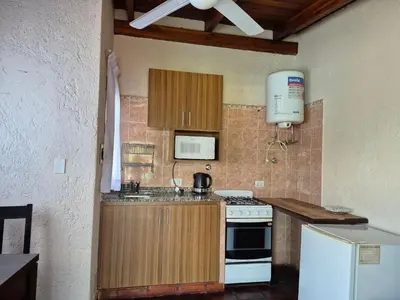 a kitchen with a white stove and a refrigerator at Solares de Tanti in Tanti Nuevo