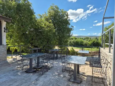 a group of tables and chairs on a patio at Solares de Tanti in Tanti Nuevo