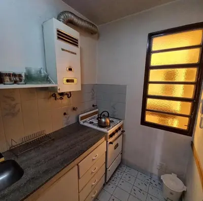 a kitchen with a sink and a stove top oven at Edificio Trebol - Departamento en pleno centro de Carlos Paz in Villa Carlos Paz
