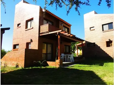 a large brick house with a balcony on it at Complejo los Espinillos de Merlo in Merlo