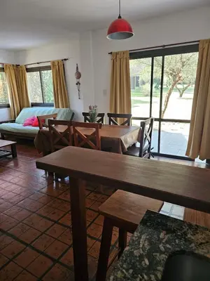 a living room with tables and chairs and a couch at Complejo los Espinillos de Merlo in Merlo