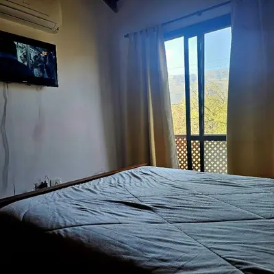 a bedroom with a large bed with a window at Complejo los Espinillos de Merlo in Merlo