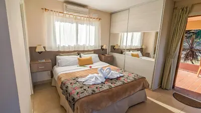 a hotel room with a bed and a large window at Mirador Serrano in Merlo