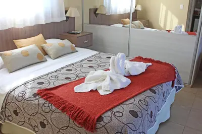 a hotel room with a bed with towels on it at Mirador Serrano in Merlo