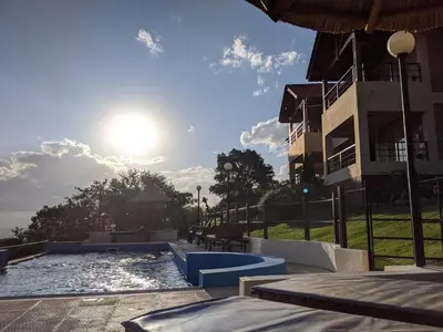 a swimming pool in front of a building at Mirador Serrano in Merlo