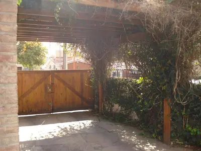 an entrance to a fence with a wooden gate at Casa Villa Carlos Paz in Villa Carlos Paz