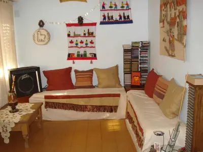 a living room with a bed and a couch at Casa Villa Carlos Paz in Villa Carlos Paz