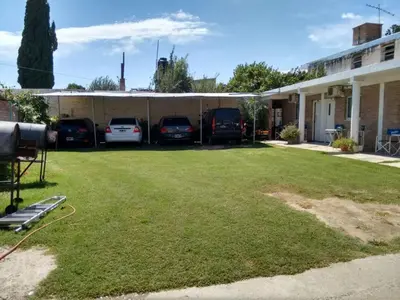 a yard with cars parked in a garage at Complejo Navi in Mina Clavero