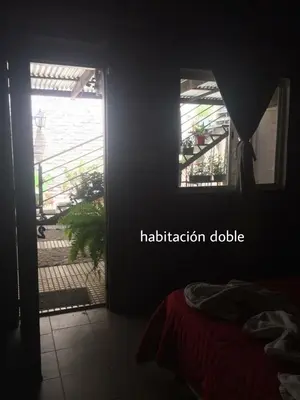a room with a door and a window with a meditation double at Complejo Navi in Mina Clavero