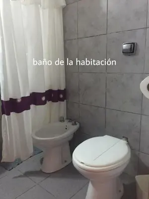 a bathroom with a toilet and a bidet at Complejo Navi in Mina Clavero