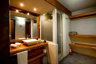 a bathroom with a sink and a mirror at SUITES ALITHUÉ in La Cumbrecita