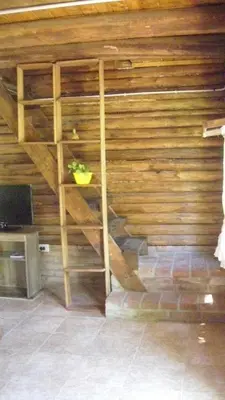 a wooden wall with a staircase in a room at Cabaña Atha Iti in Villa General Belgrano
