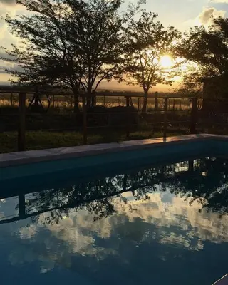 a reflection of the sunset in a swimming pool at La Antonia Elvira in Los Reartes