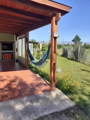 a patio with a hammock on a house at La Antonia Elvira in Los Reartes