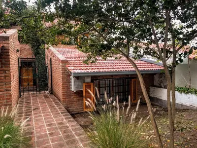a brick house with a gate and a brick walkway at Cozy apartment in Cordoba in Cordoba