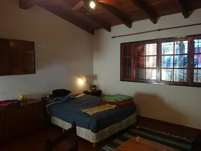 a bedroom with a bed and two windows at Cozy apartment in Cordoba in Cordoba