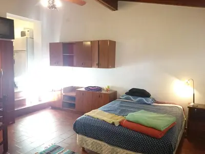 a bedroom with a bed and a room with a kitchen at Cozy apartment in Cordoba in Cordoba