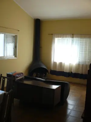 a living room with a fire place in the corner at Rocio de Luna in Mina Clavero