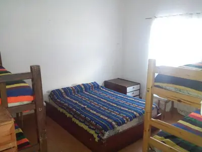 a bedroom with two bunk beds and a window at Rocio de Luna in Mina Clavero