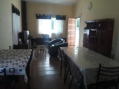 a living room with tables and chairs and a living room at Rocio de Luna in Mina Clavero