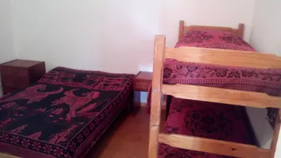 two bunk beds in a small room with a bed at Rocio de Luna in Mina Clavero