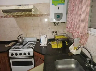 a small kitchen with a stove and a sink at Casa Reinamora in Villa Parque Siquiman