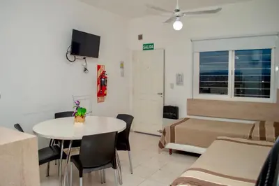 a room with a table and a bed and a bedroom at Sierras Apartamentos in Villa Santa Cruz del Lago