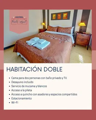a poster for a hotel room with a bed with two towels at Hosteria Valle Azul in Villa del Dique