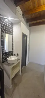 a bathroom with a sink and a mirror at Vivisierras, Duplex a estrenar con pileta privada centro Villa Carlos Paz, 3 dormitorios, 2 baños, vista in Villa Carlos Paz