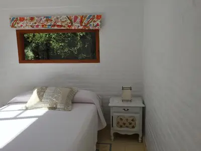 a small bedroom with a bed and a window at Raco De La Calma in Nono