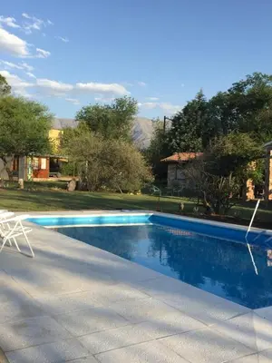 a swimming pool with a chair next to a house at Raco De La Calma in Nono