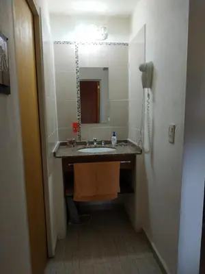 a bathroom with a sink and a mirror at Cabañas Cuncumen in Los Reartes